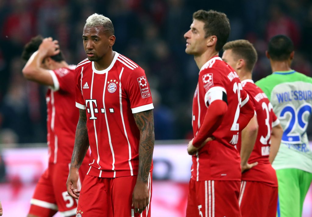 Bayern Munich's Jerome Boateng (L) and Thomas Muller look dejected after the match.
