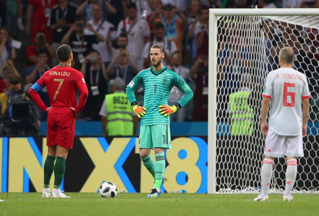 Portugal's Cristiano Ronaldo prepares to take a penalty as Spain's David De Gea looks on.