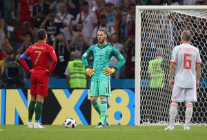 Portugal's Cristiano Ronaldo prepares to take a penalty as Spain's David De Gea looks on.