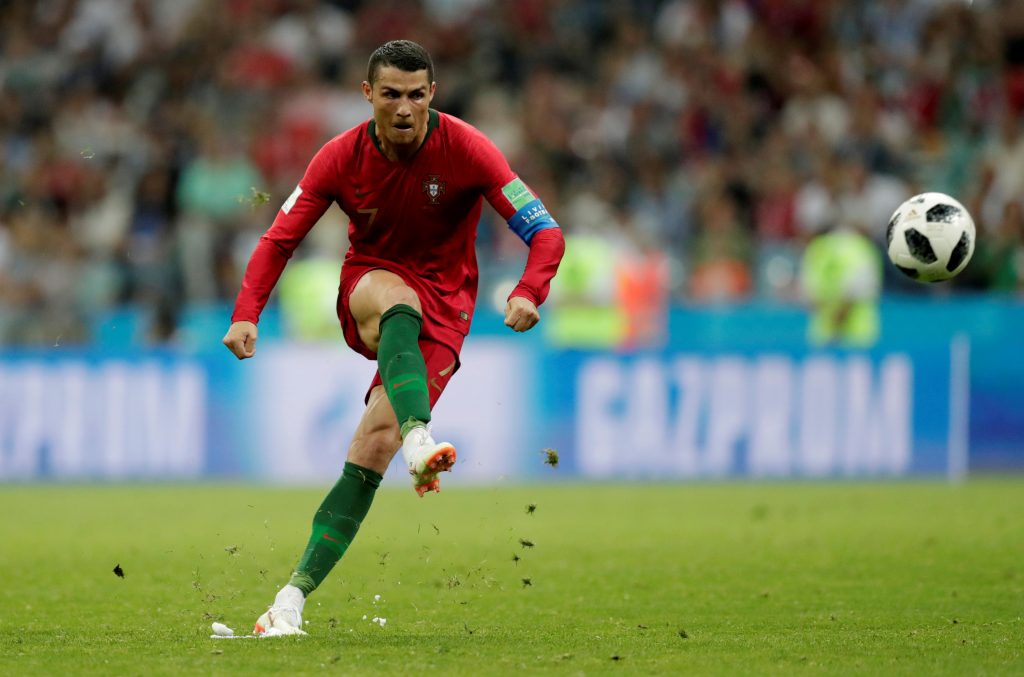 Portugal's Cristiano Ronaldo scores their third goal from a free kick to complete his hat-trick.