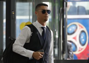 Cristiano Ronaldo walks towards a check-in counter before the departure.