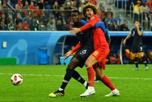 Belgium's Marouane Fellaini in action with France's Paul Pogba.