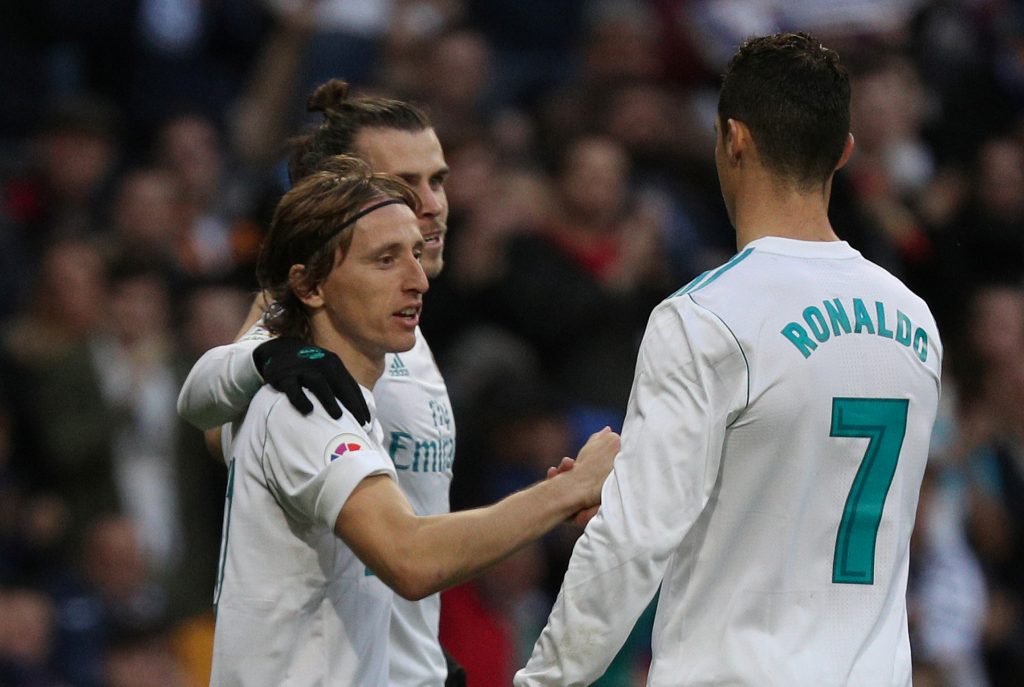 Real Madrids Luka Modric celebrates scoring their fourth goal with Gareth Bale and Cristiano Ronaldo.