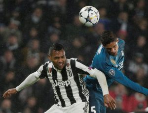 Real Madrid's Raphael Varane in action with Juventus' Alex Sandro.