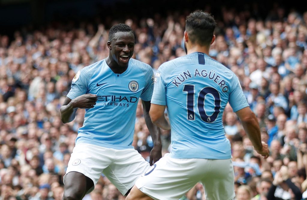 Man City's Sergio Aguero celebrates scoring their third goal with Benjamin Mendy.
