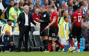 Manchester United manager Jose Mourinho speaks with Luke Shaw.