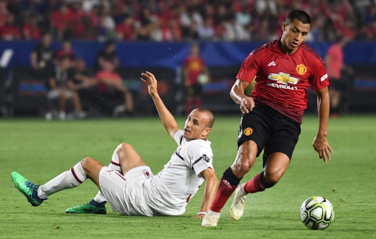 Alexis Sanchez (7) moves the ball away from Milan defender Luca Antonelli (31) in the second half during an International Champions Cup soccer match.