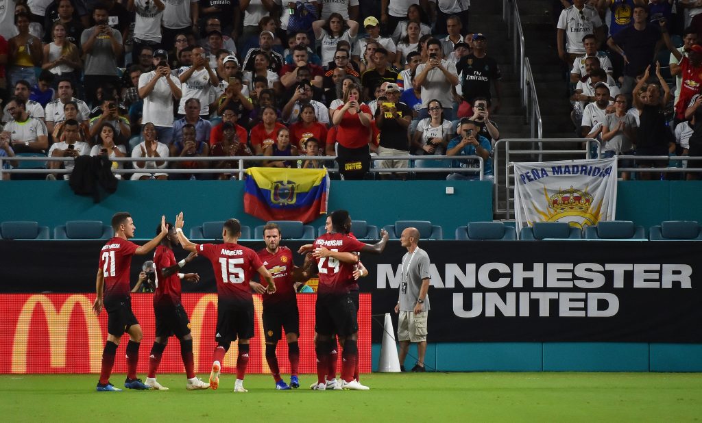 Manchester United teammates celebrate the goal of forward Alexis Sanchez (7) against Real Madrid during the first half of an International Champions Cup soccer match.
