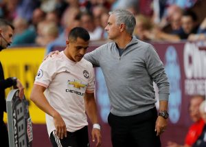 Manchester United's Alexis Sanchez with manager Jose Mourinho as he is substituted off.