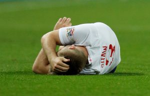 England's Luke Shaw lies on the pitch after sustaining an injury.