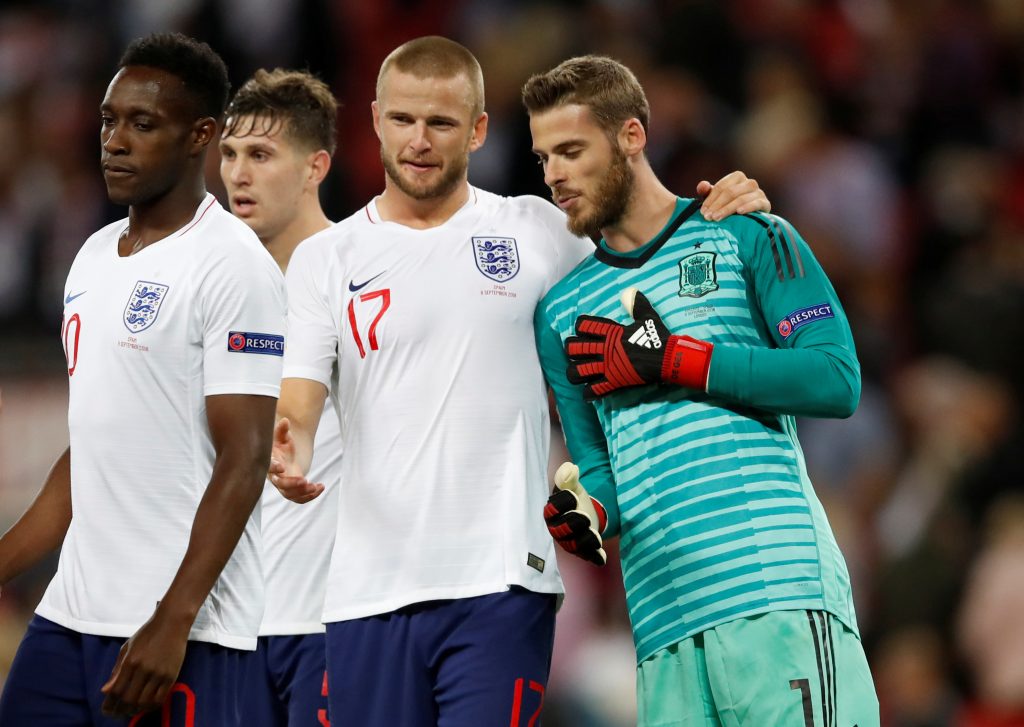 England's Eric Dier talks to Spain's David De Gea.
