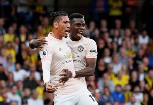 Manchester United's Chris Smalling celebrates scoring their second goal with Paul Pogba.