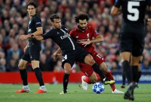 PSG's Juan Bernat in action with Liverpool's Mohamed Salah.