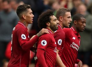 Liverpool's Mohamed Salah celebrates scoring their third goal with teammates.