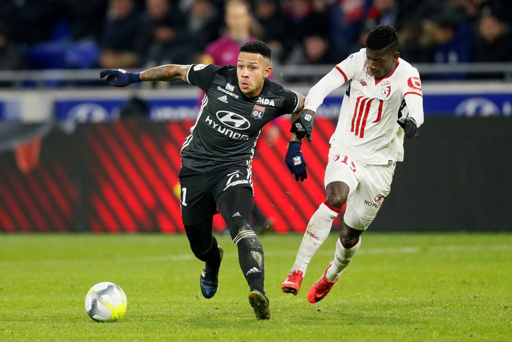 Lyon's Memphis Depay in action with Lilles Edgar Ie.
