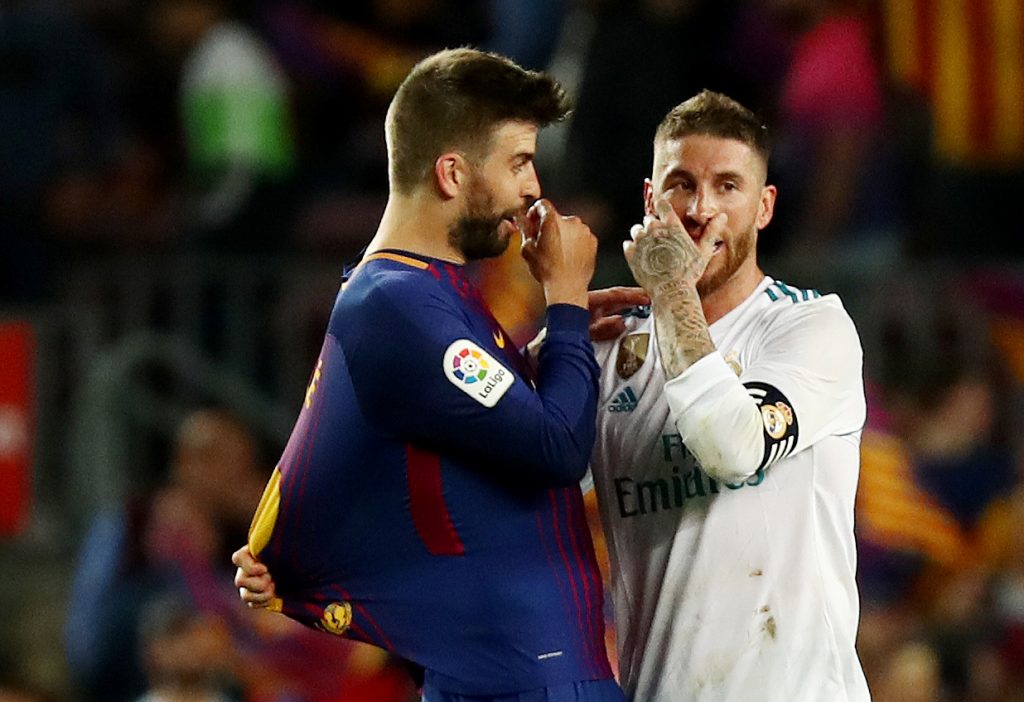Barcelona's Gerard Pique talks with Real Madrid's Sergio Ramos at the end of the match.