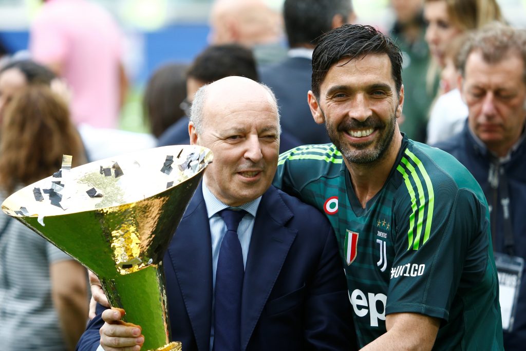 Juventus' Gianluigi Buffon celebrates winning the league with Juventus CEO Giuseppe Marotta and the trophy.