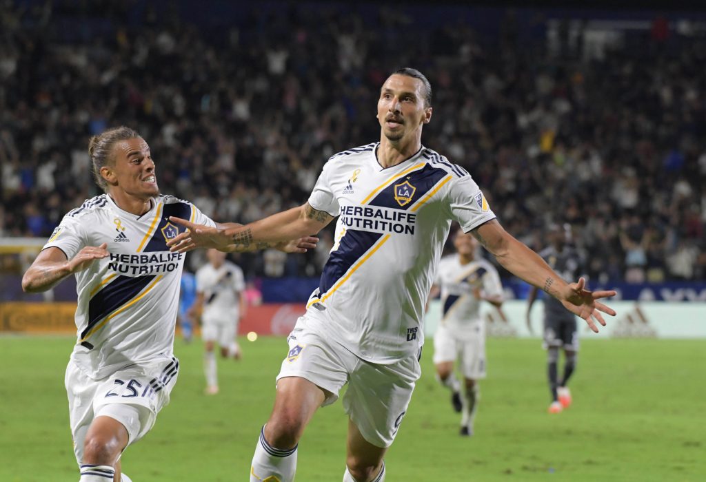 LA Galaxy forward Zlatan Ibrahimovic (9) celebrates with defender Rolf Feltscher (25).