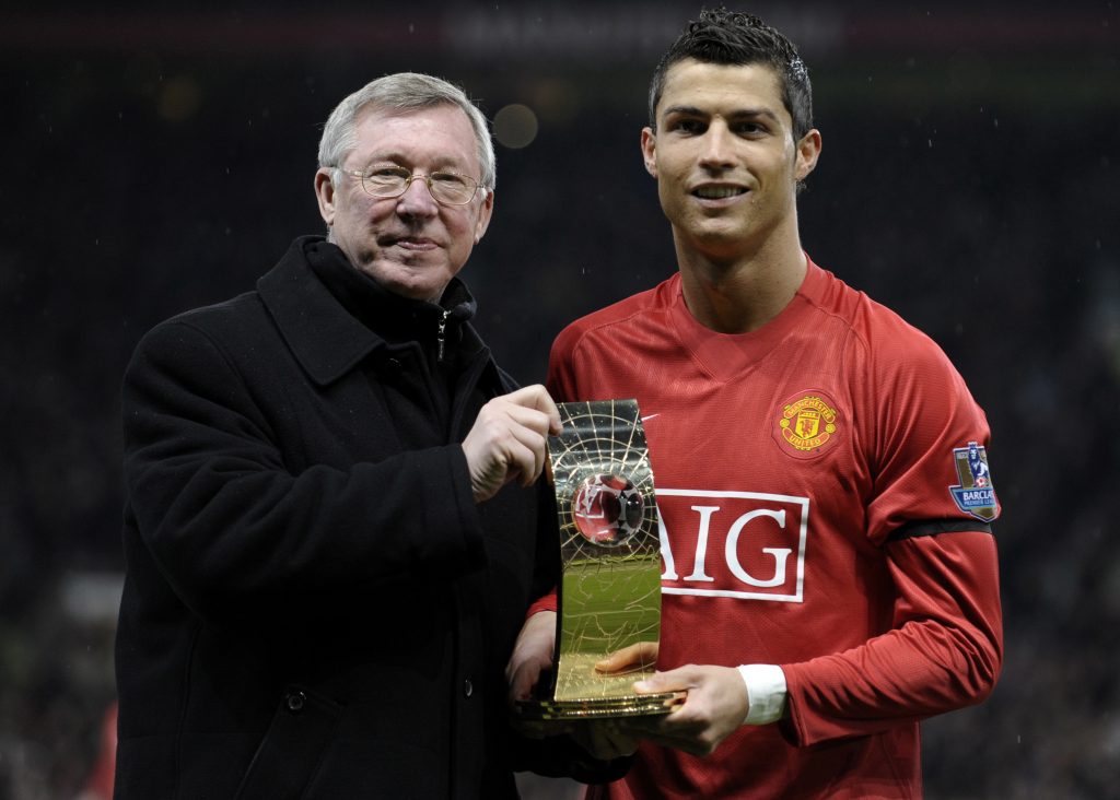 Cristiano Ronaldo receives the World Footballer of the Year Award from Sir Alex Ferguson.