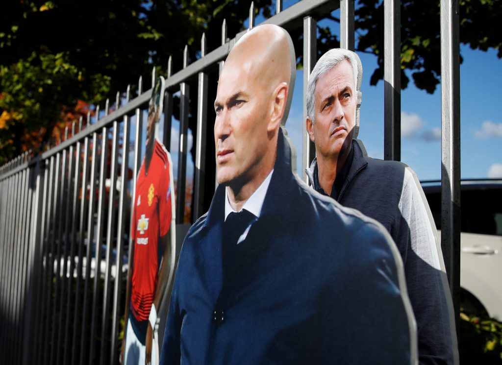 Cardboard cutouts of Jose Mourinho and Zinedine Zidane outside the stadium.