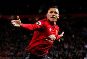 Manchester United's Alexis Sanchez celebrates scoring their third goal.