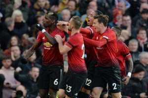 Manchester United's Paul Pogba celebrates scoring their first goal with teammates.