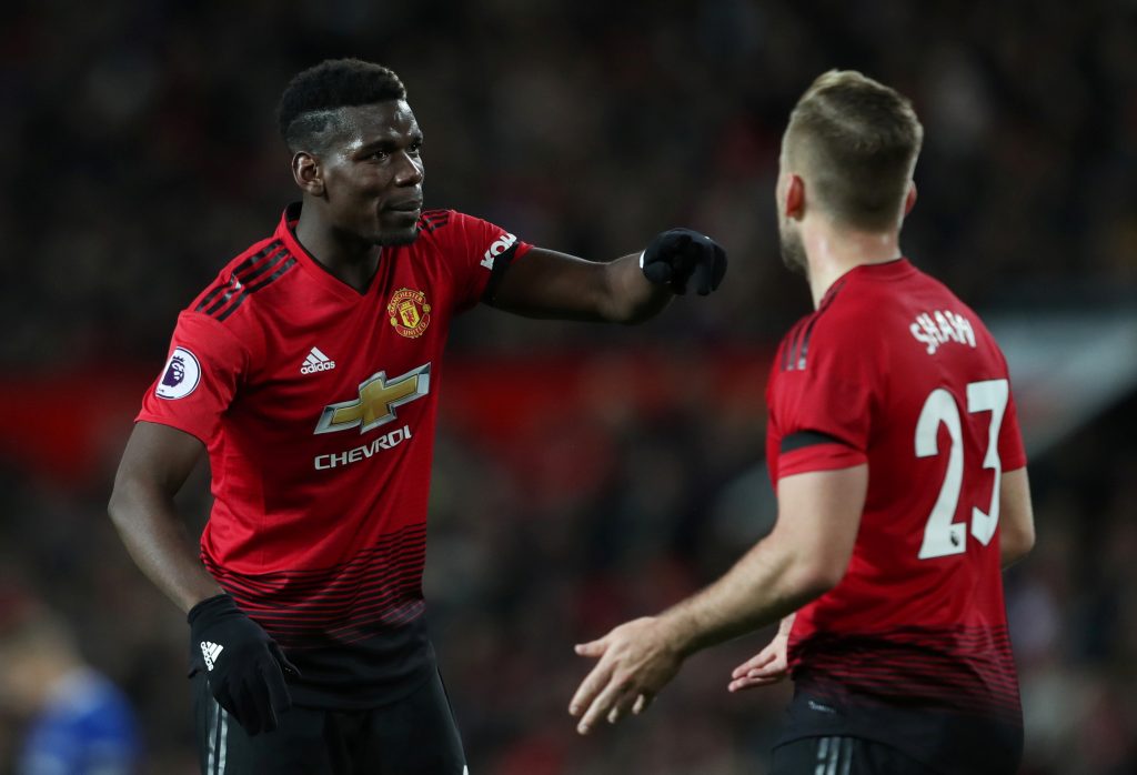 Manchester United's Paul Pogba with teammate Luke Shaw.