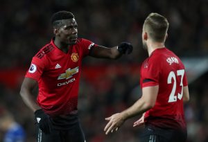 Manchester United's Paul Pogba with teammate Luke Shaw.