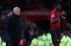 Jose Mourinho looks on alongside Paul Pogba.