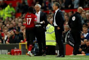 Manchester United's Fred with Jose Mourinho after being substituted.