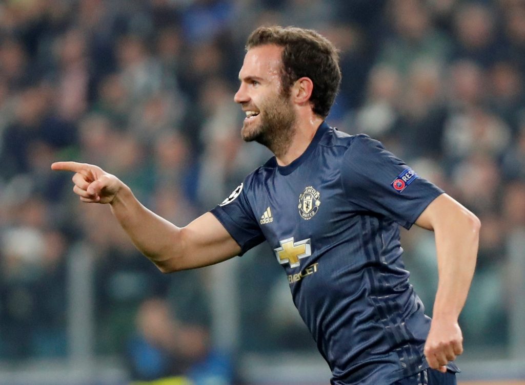 Manchester United's Juan Mata celebrates scoring their first goal.