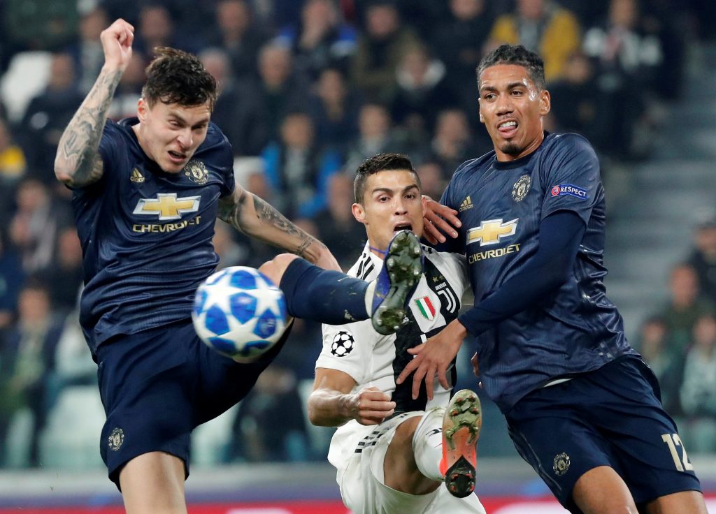 Juventus' Cristiano Ronaldo in action with Manchester United's Victor Lindelof and Chris Smalling.