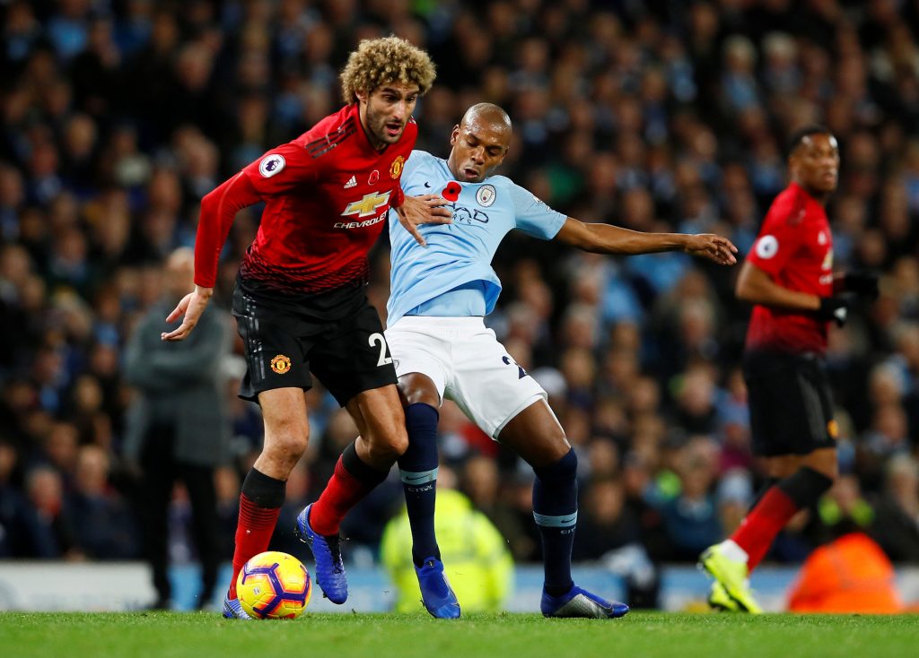 Manchester United's Marouane Fellaini in action with Man City's Fernandinho.