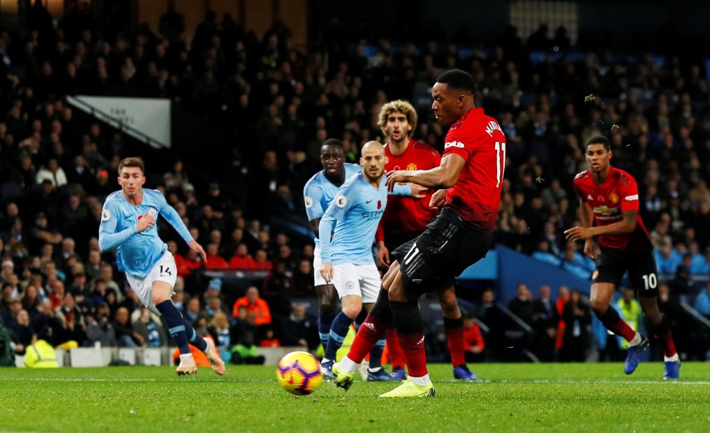 Manchester United's Anthony Martial scores their first goal from the penalty spot.