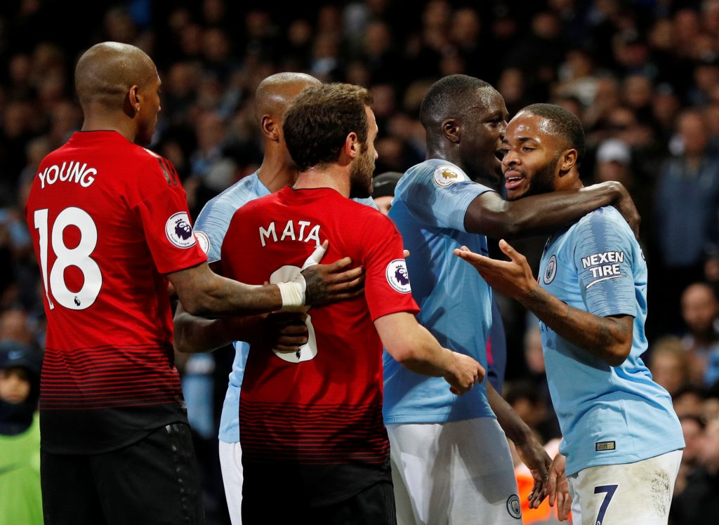 Man City's Raheem Sterling clashes with Manchester United's Juan Mata.