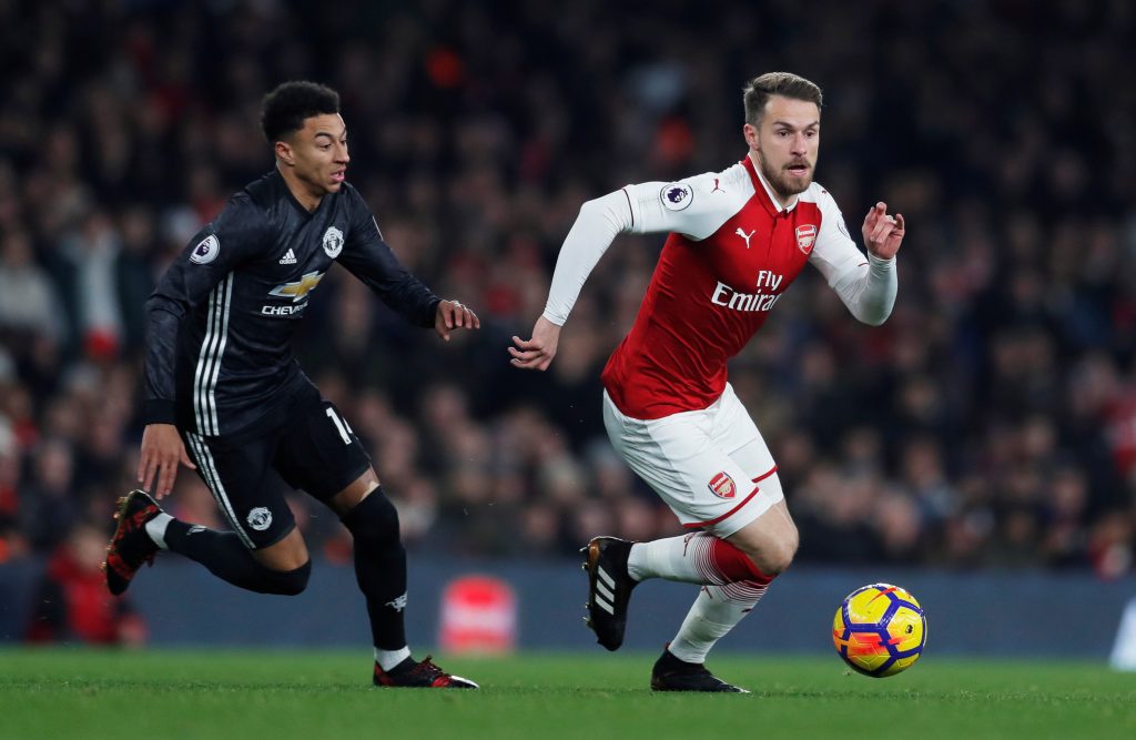 Arsenal's Aaron Ramsey in action with Manchester United's Jesse Lingard.