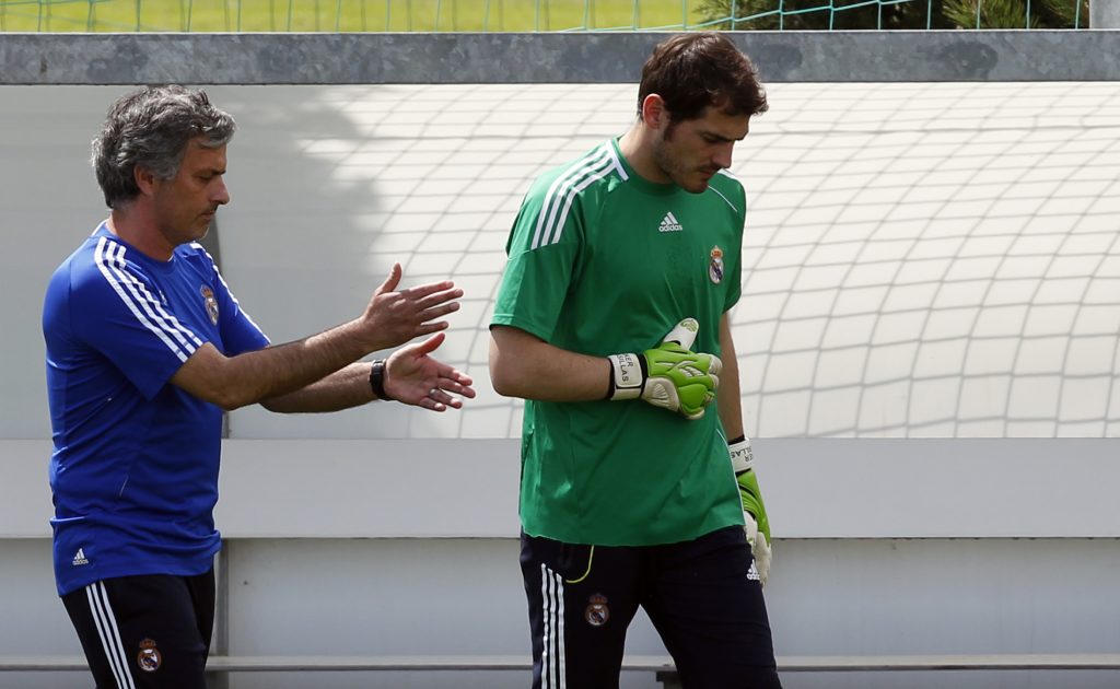 Real Madrid's coach Jose Mourinho (L) gestures beside goalkeeper and captain Iker Casillas during their team's training session.
