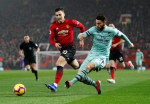 Arsenal's Sead Kolasinac in action with Diogo Dalot.