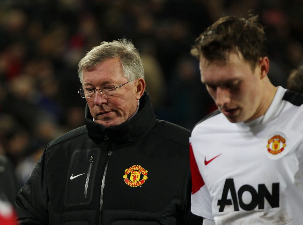 Manchester United's manager Sir Alex Ferguson (L) and Phil Jones dejected at half time.