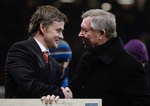 Sir Alex Ferguson (R) and Ole Gunnar Solskjaer shakes hands after a presentation to Solskjaer before the match.