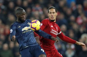 Liverpool's Virgil van Dijk in action with Manchester United's Romelu Lukaku.