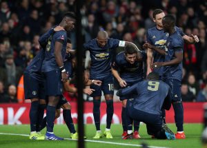 Manchester United's Alexis Sanchez celebrates scoring their first goal with team mates.
