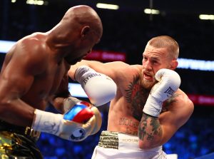 Conor McGregor moves in with a hit against Floyd Mayweather Jr.