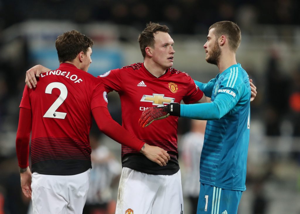 Phil Jones celebrates with David de Gea and Victor Lindelof at the end of the match.