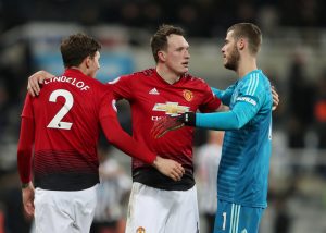 Phil Jones celebrates with David de Gea and Victor Lindelof at the end of the match.