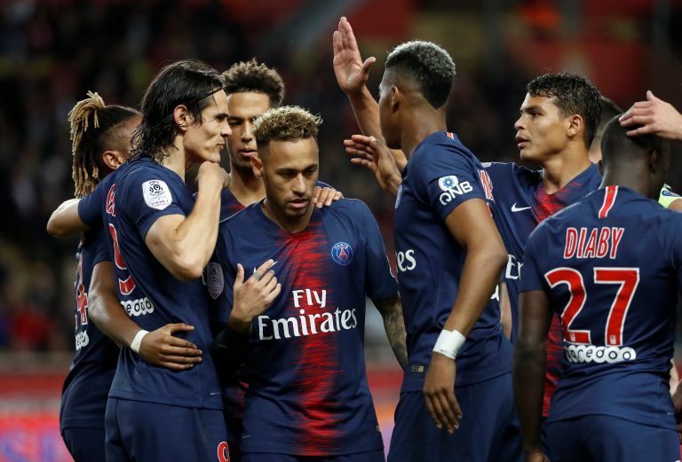 PSG's Edinson Cavani celebrates scoring their third goal and completing his hat-trick with Neymar and team mates.