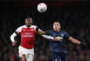 Arsenal's Ainsley Maitland-Niles in action with Man United's Alexis Sanchez.