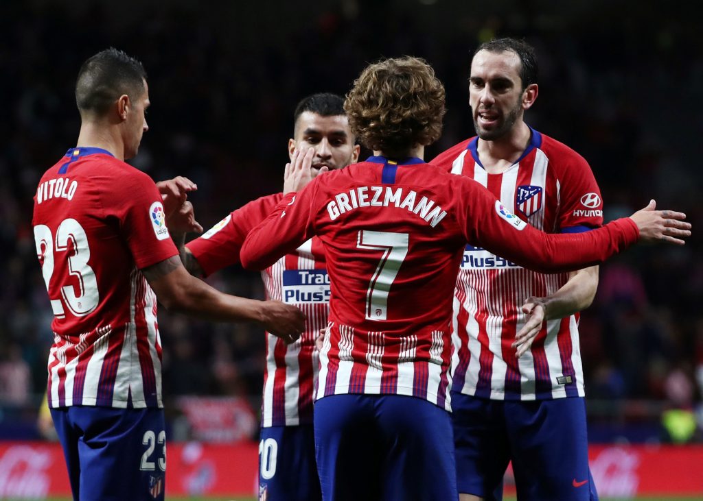 Atletico Madrid's Antoine Griezmann celebrates scoring their second goal with Diego Godin and team mates.