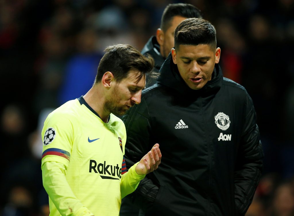 Barcelona's Lionel Messi and Manchester United's Marcos Rojo at half time.
