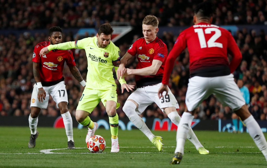 Manchester United's Scott McTominay in action with Barcelona's Lionel Messi.